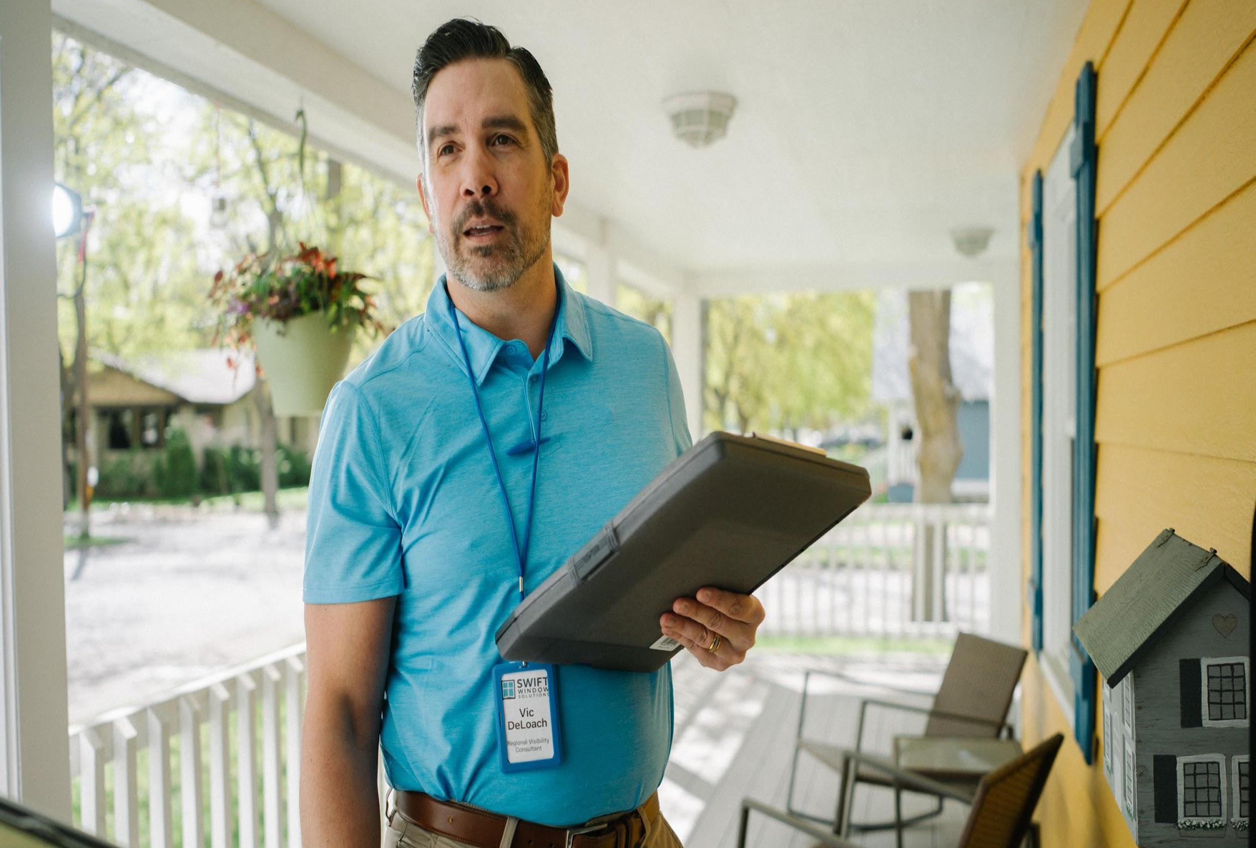 Man holding tablet on porch